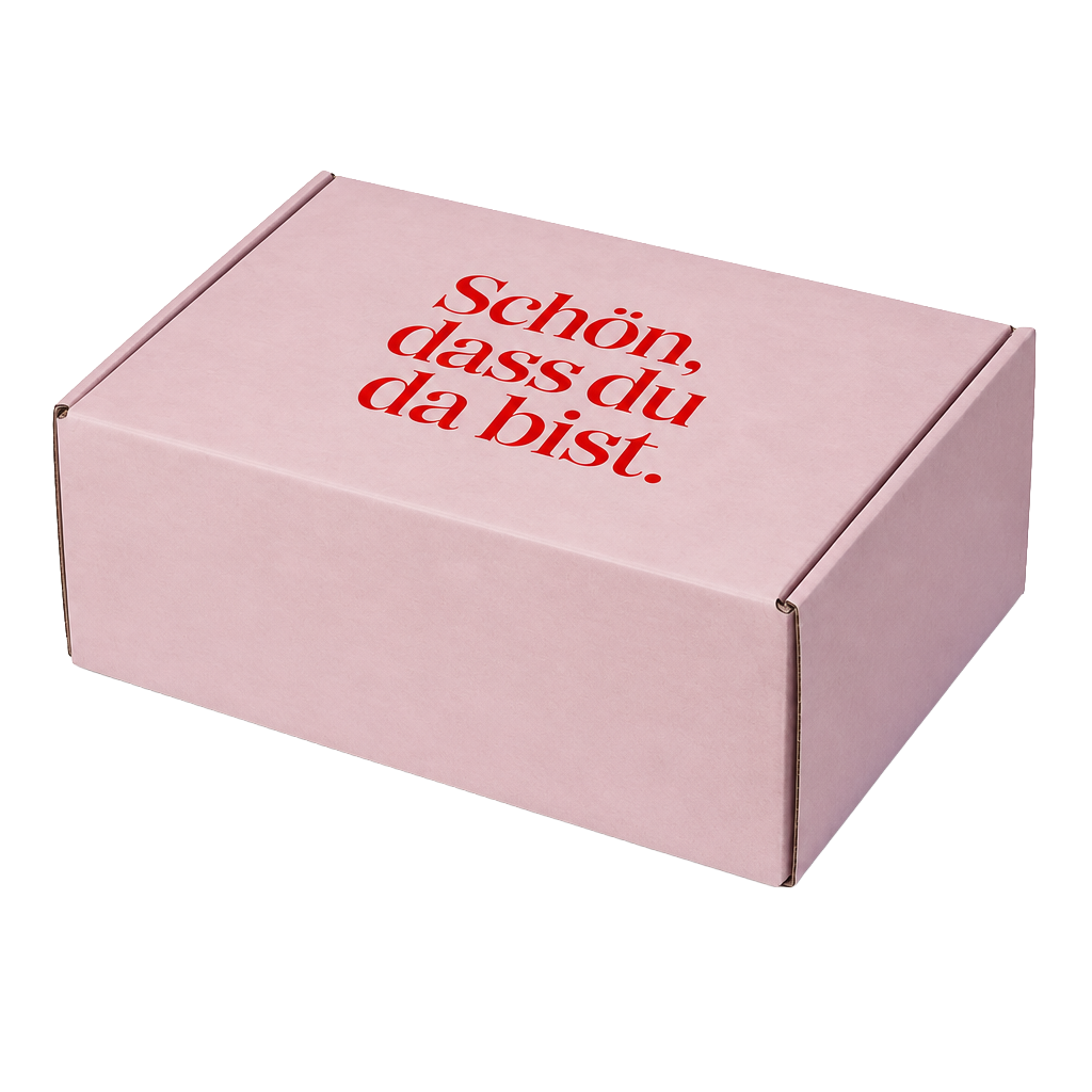 Rosafarbene Geschenkbox mit rotem Aufdruck Schön, dass du da bist.